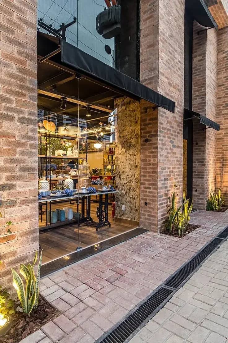 Commercial brick storefront and paver entry walkway with glass facade