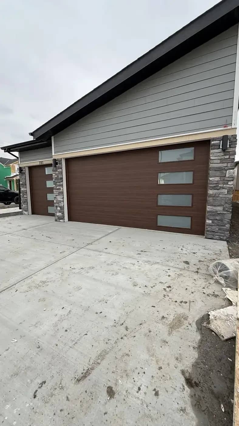 Garage apron concrete and stone pillars at a modern home