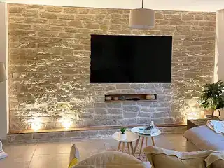 Interior stone fireplace and feature wall with finished living room surround