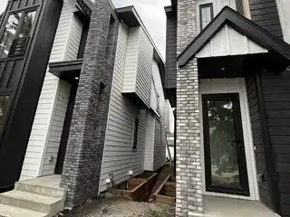 Modern entry stone columns and exterior masonry for a mixed project review